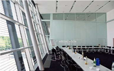 Meeting room with a long table and an angled exterior wall